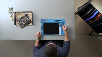 A top down view of a technician repairing a Surface device